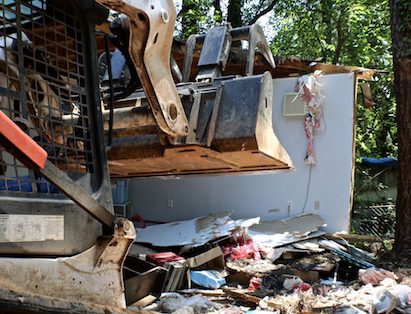 Bobcat Tearing Down Small House